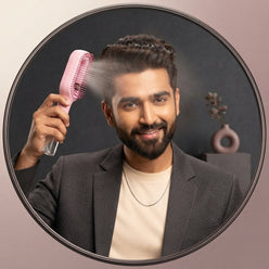 Vikram Patel, a grooming influencer, holding a 2-in-1 spray comb in a professional, minimalist portrait.